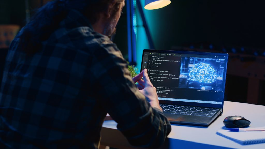 teleworking it specialist in apartment office uses programming to upgrade ai
