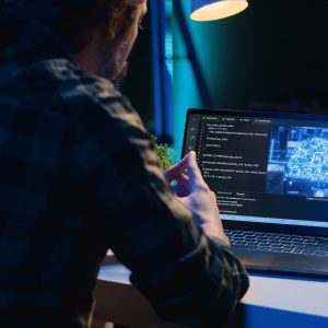 teleworking it specialist in apartment office uses programming to upgrade ai